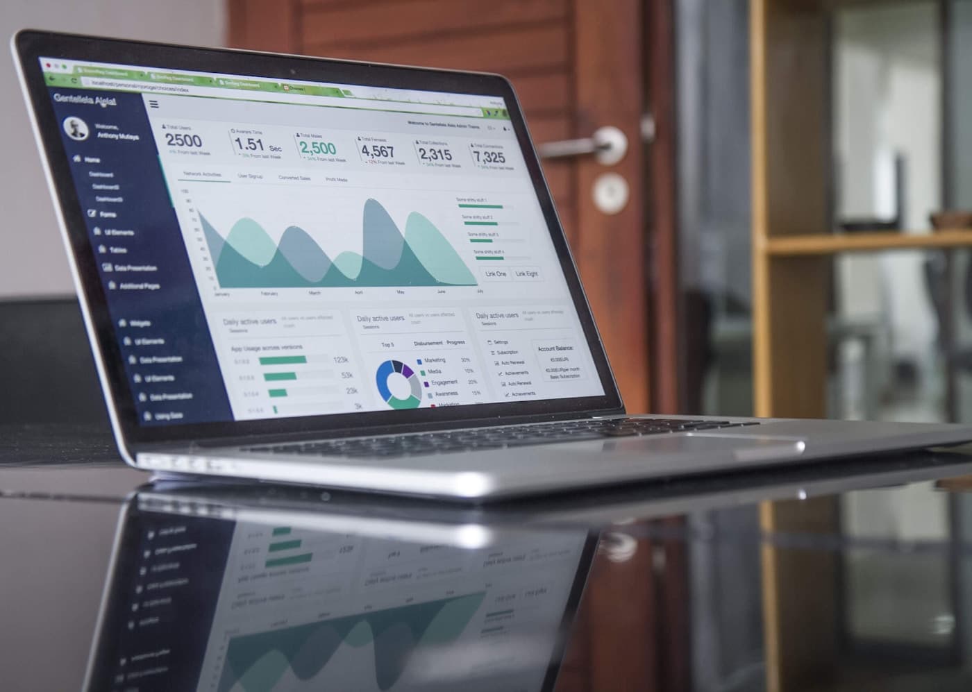 Laptop and productivity tools on a desk — church management software overview